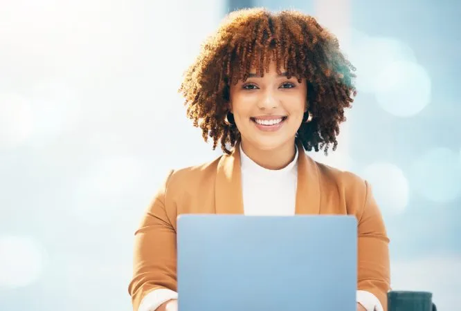 happy-laptop-and-portrait-of-black-woman-in-offic-2025-04-06-09-53-35-utc-scaled-e1749027246981